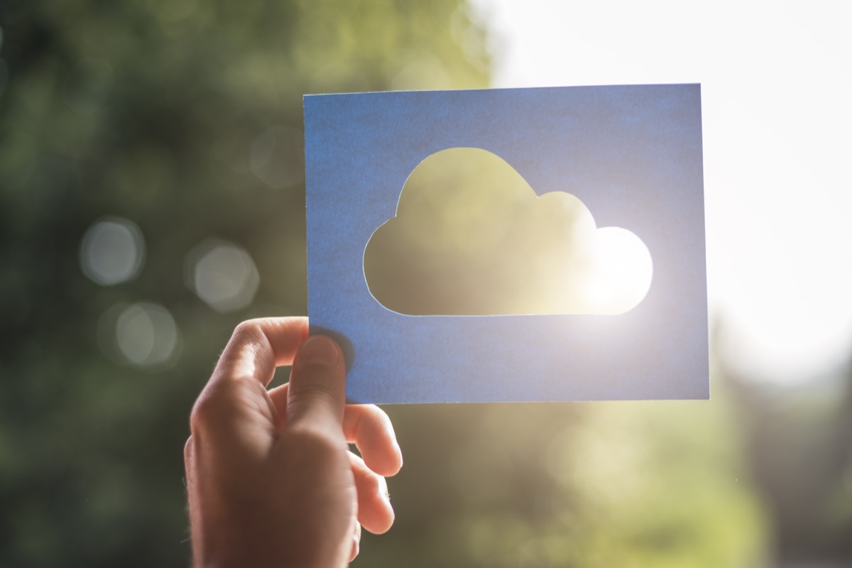 Hand holding a cloud computing symbol